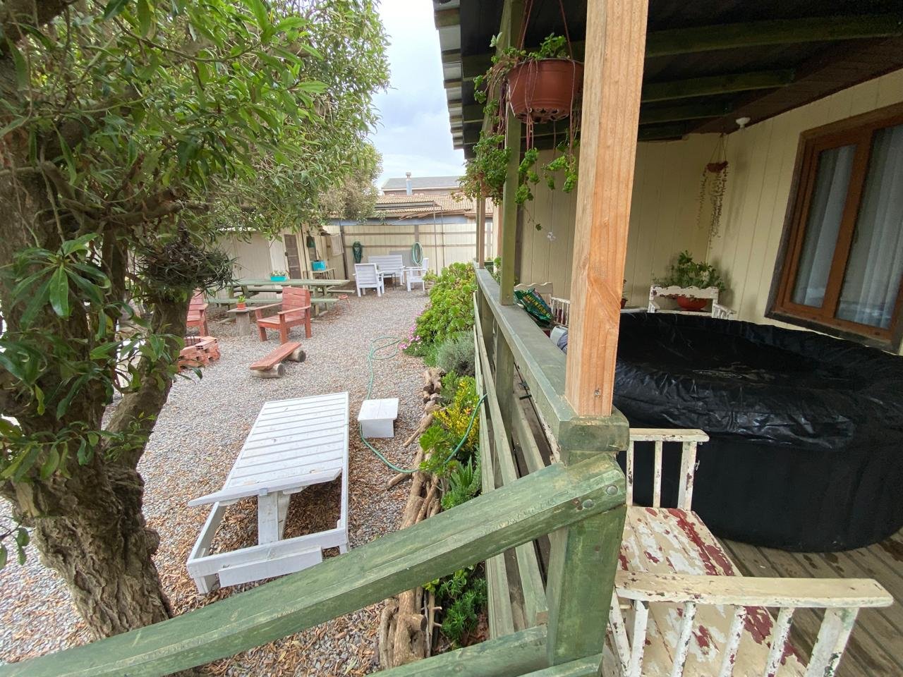 Terraza longitudinal techada con mesa y plantas