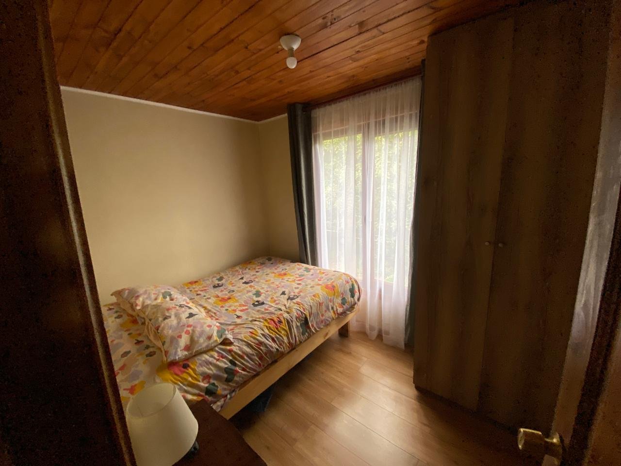 Dormitorio con cama doble, clóset y luz natural